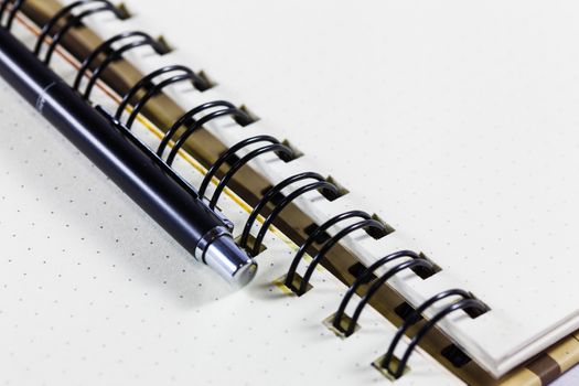 Open notebook with pen on clean sheets