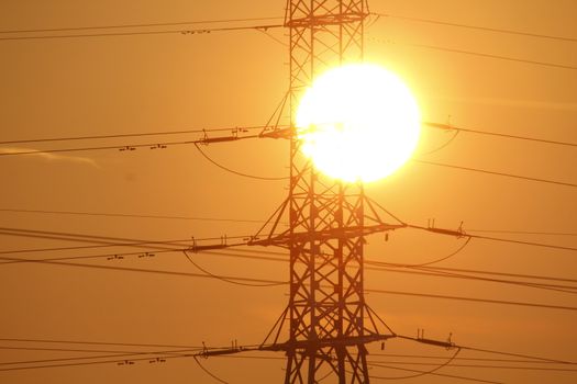 The power lines with the sun in the background