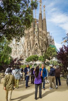 BARCELONA, SPAIN - JUNE 01 People photograph the Sagrada Familia cathedral, designed by Antoni Gaudi, in Barcelona, Spain, on June 01, 2013. It is a church with a modernist architecture, initiated in 1882, and still under construction