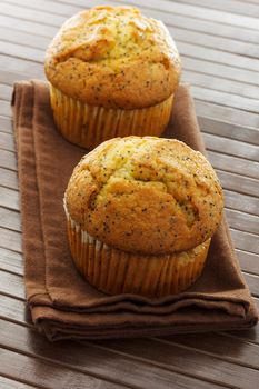 Delicious poppy seed muffins on brown napkin
