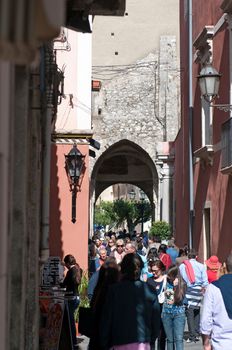 Taormina, Italy - May 1, 2011: Always the populous, Corso Umberto - main street in old Taormina, famous tourist resort, the most luxury town on Sicilian coastline, Sicily, Italy
