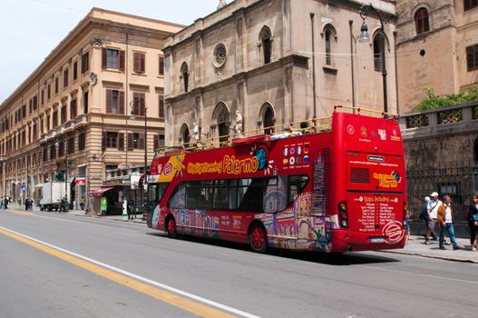 Palermo, Italy - May 2, 2011: Tourist bus on street of Palermo. Crowds of tourists visit Palermo - a historic city in Southern Italy, the capital of Sicily and the Province of Palermo. Italy