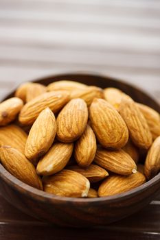 Almonds in wooden bowl