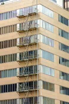 Fire escape climbing up a tall building in downtown Portland, Oregon