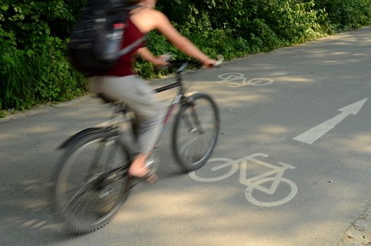 Motion Blur Of A Cyclist On A Cycle Lane On A Sunny Day