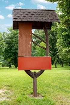 Empty sign on a trail, Tourist Directory in park with blue sky and trees in background