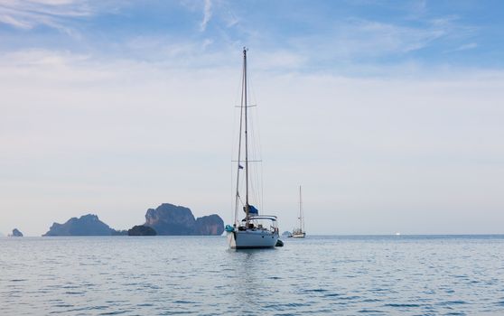 white beautiful yacht against rocks. Thailand