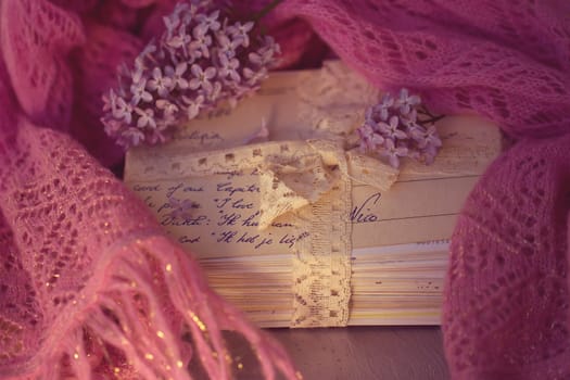 Stacks of old letters with lavender on soft scarf