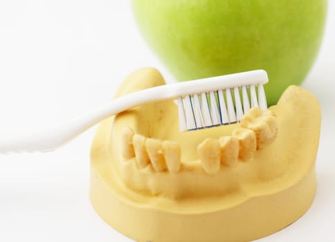 Dental health care concept, green apple and toothbrush