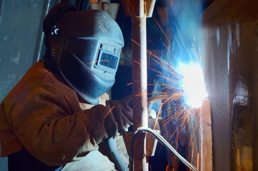 a welder working at shipyard in day time