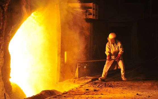 worker takes a sample at steel company 