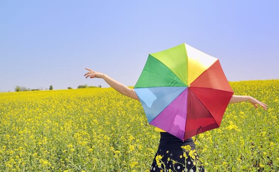 a young attractive girl with a colorful umbrella