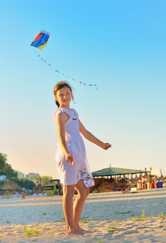 Girl on beach with kite 