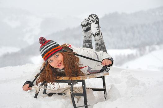 young  girl on sleigh