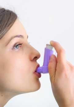 young girl using an inhalator, preventing a cold and respiration problems