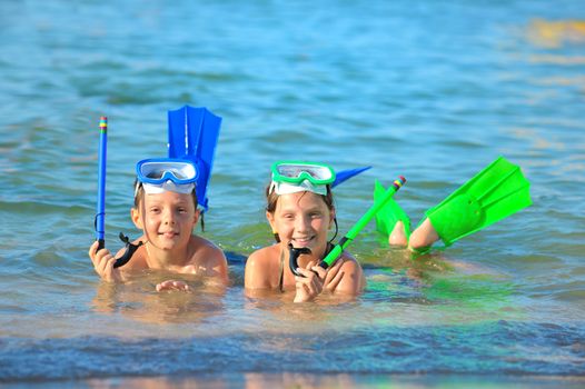 children on beach with snorkles