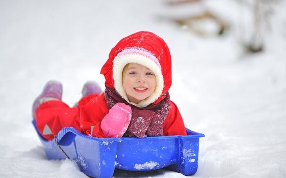 Little girl on sleigh 