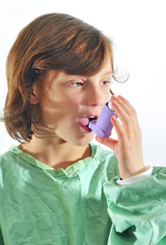 little girl using inhaler