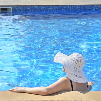 Woman sitting in a swimming pool