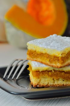 pumpkin pie on black dish