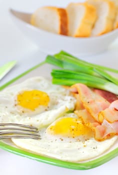 breakfast with bacon and fried eggs 