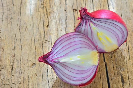 Red onions isolated on wooden background