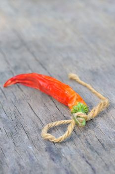 Red chili peppers over wooden background 