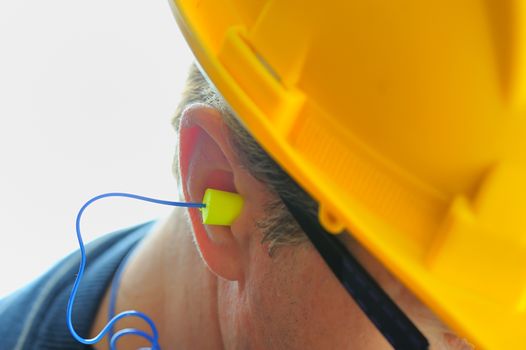 yellow earplug into the ear