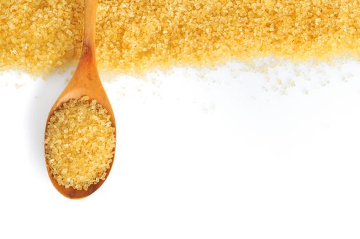 spoon and cane sugar on white background