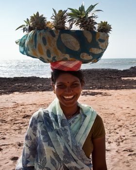 Indian girk selling the fruits on the beach