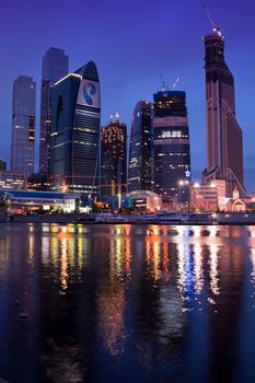 Business area Moscow City. Night view over the river