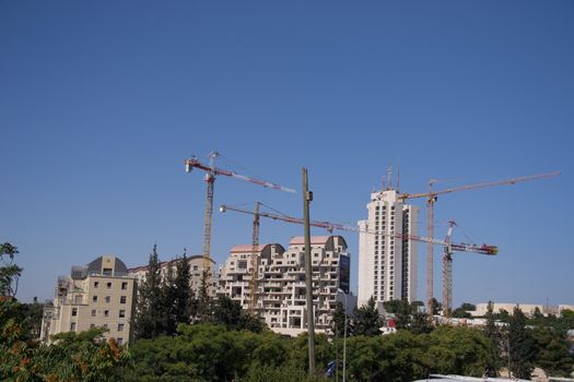 Construction cranes over new apartment buildings