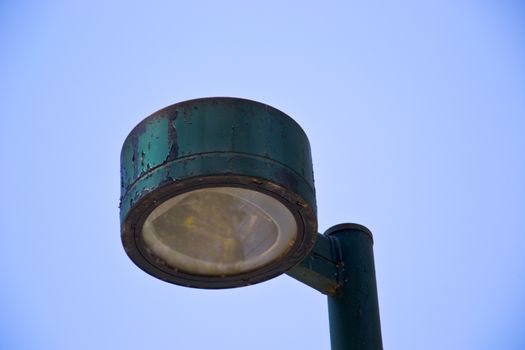 Old lamp against blue sky