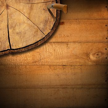 Wooden background with trunk section, folding knife and shadows