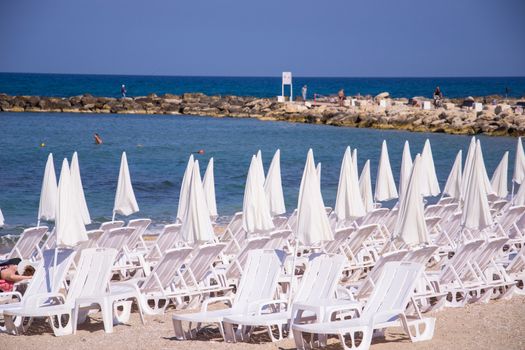 Beach umbrellas and sunbeds on the sand.Tel Aviv