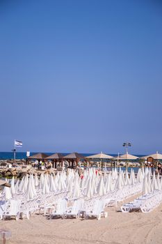 Beach umbrellas and sunbeds on the sand.Tel Aviv