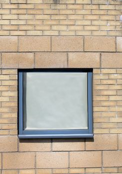 Window on exterior of modern brick office building.