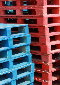 Closeup of red and blue wooden pallets.