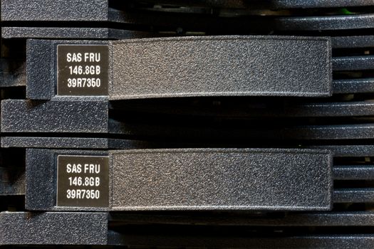 Row of hard drives mounted in a rack in a data center