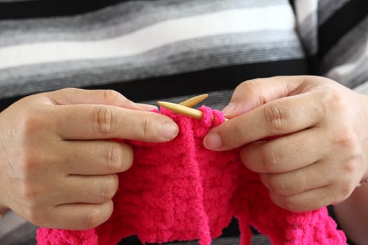 Hands of a young woman knitting