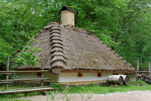 Traditional farmer's house under the thatch roof in open air museum, Kiev, Ukraine