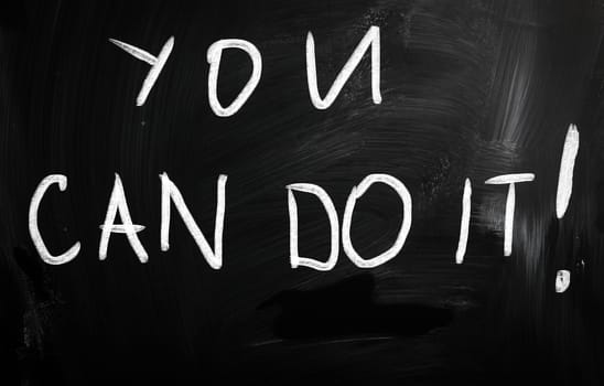 "You can do it" handwritten with white chalk on a blackboard