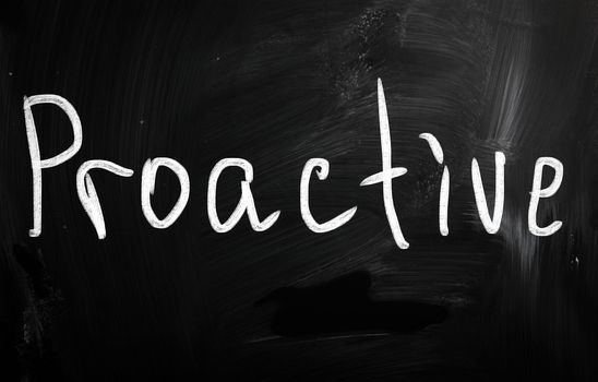 The word 'Proactive' handwritten with white chalk on a blackboard