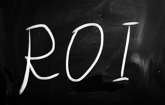 The word "ROI" handwritten with white chalk on a blackboard