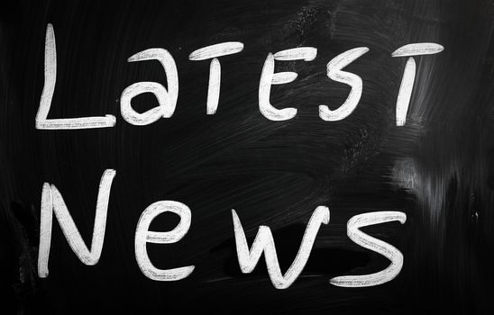 "Breaking news" handwritten with white chalk on a blackboard