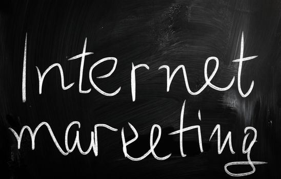 "Internet marketing" handwritten with white chalk on a blackboard