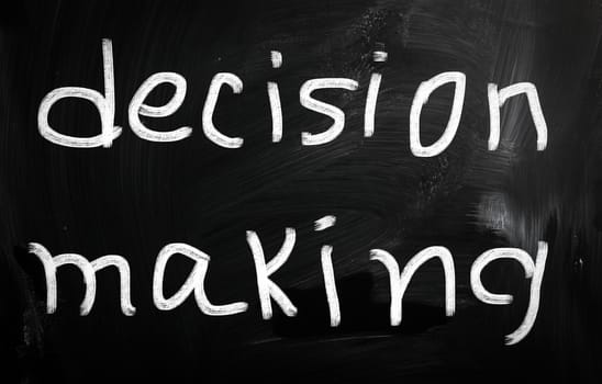 "Decision making" handwritten with white chalk on a blackboard