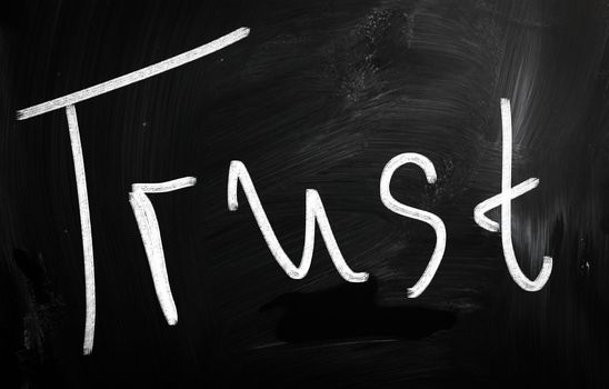 trust written with chalk on blackboard