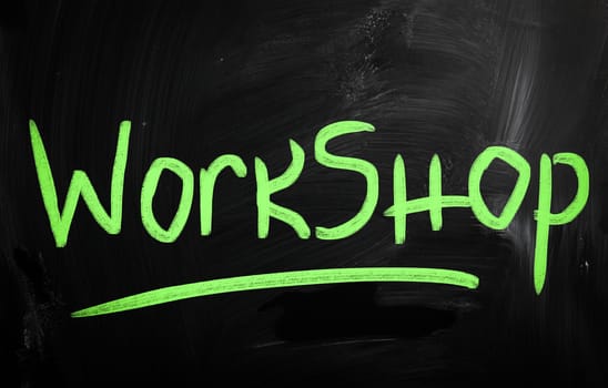 "Workshop" handwritten with white chalk on a blackboard
