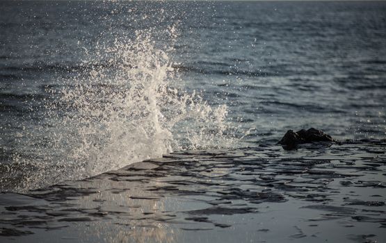 Water splashes in a stormy dark sea 